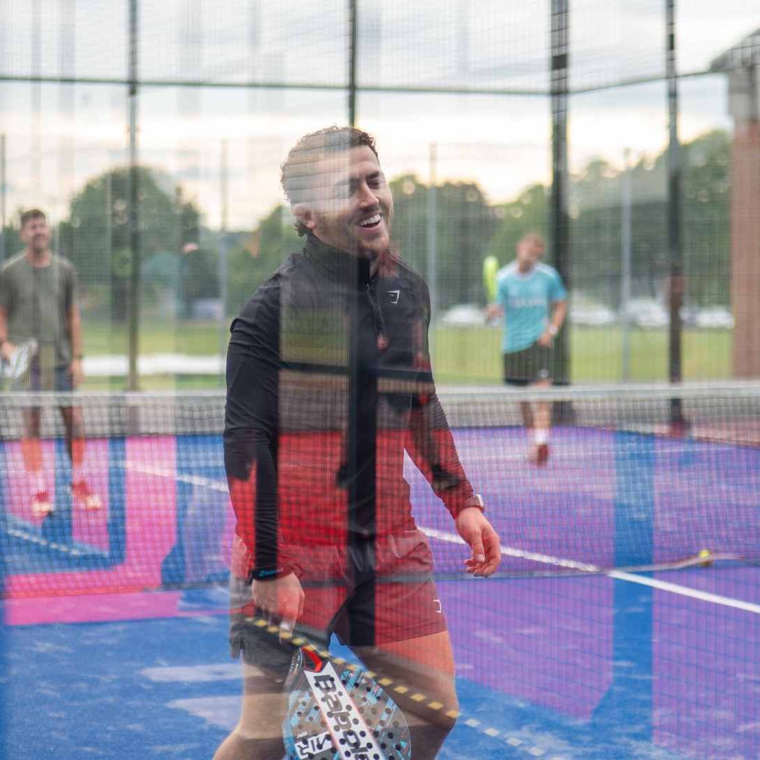 Elevate Padel Society - Ball In Net and Team Smiling